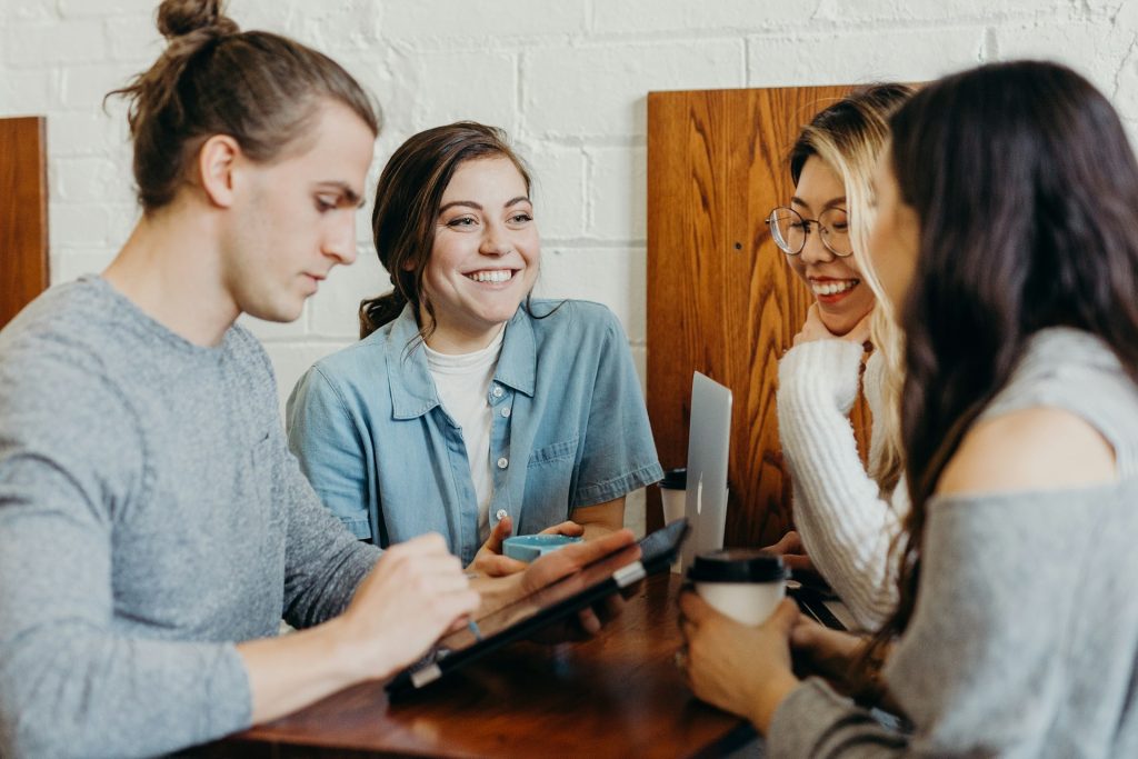 4 colleagues networking at a table