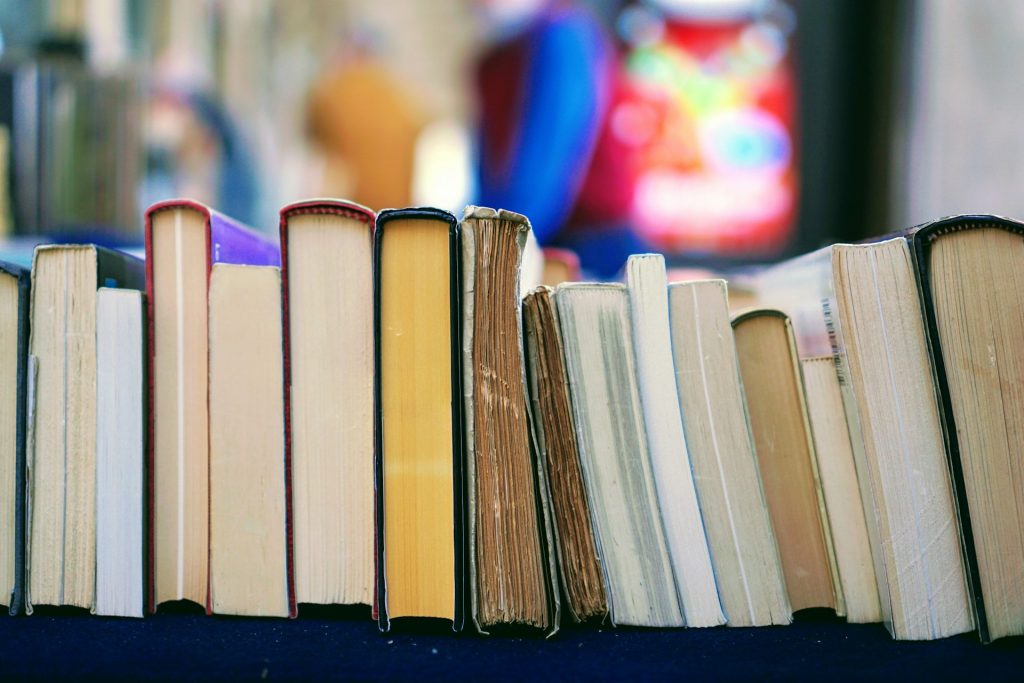 books aligned horizontally on a table